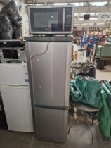 A Samsung fridge freezer and a Kenwood 900W microwave.