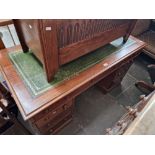 A mahogany twin pedestal desk with tooled leather writing surface, circa 1900. Later handles.