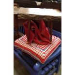 A red cow hide rug, a vintage stool and a vintage solid wood table.