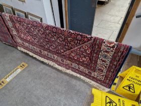 A Persian style wool carpet, red ground, made in Belgium, 200cm x 300cm (approx).