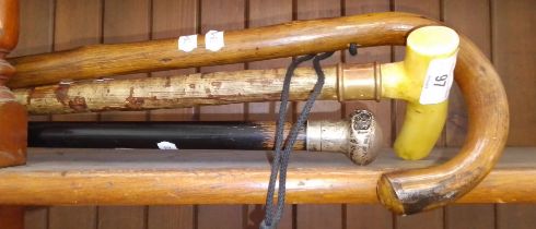 Three walking sticks including one with hallmarked silver top.