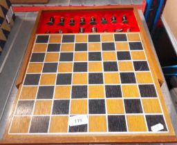 A boxed chess set with cast metal pieces