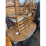 An Ercol elm extending dining table and six chairs.
