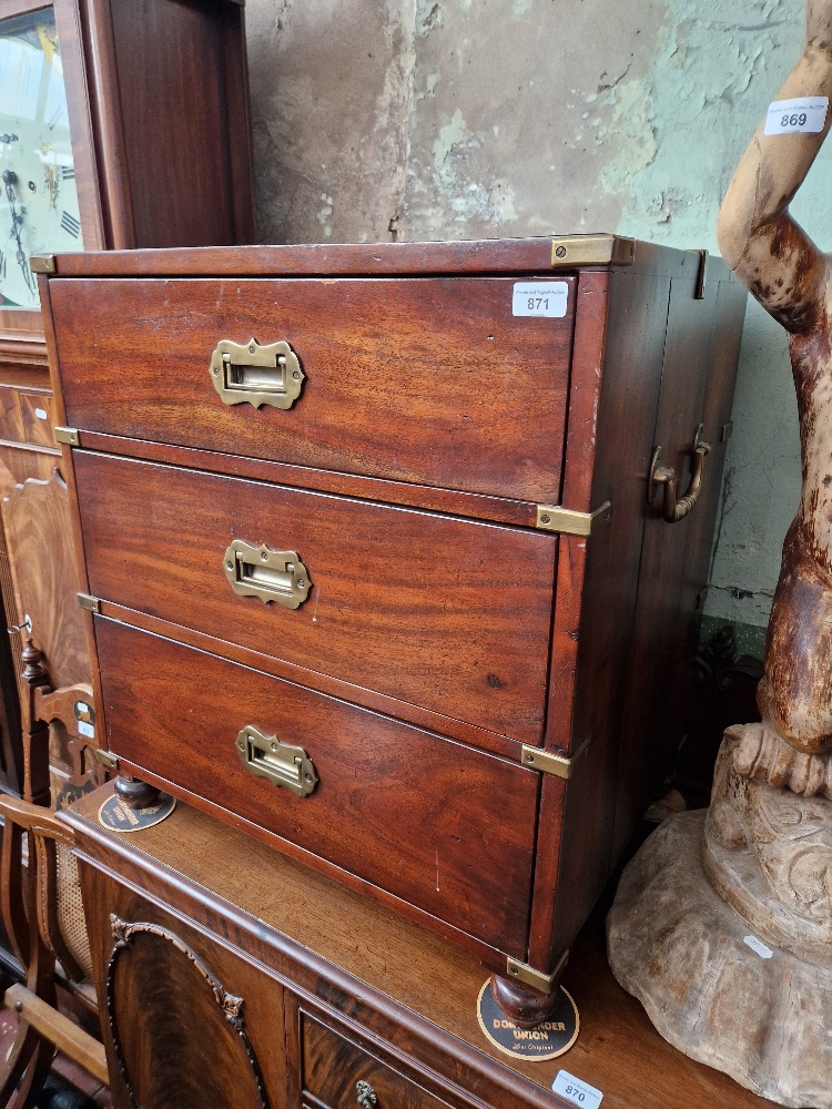 A mahogany campaign style chest of drawers.