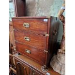 A mahogany campaign style chest of drawers.