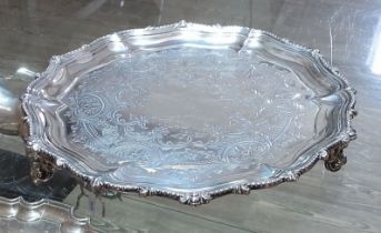 A Victorian silver salver, moulded and scalloped edge, engraved, stood on three scroll feet,