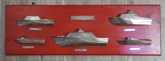 A display of cast silver half hull boats, modelled after boats produced by Anchorage Ltd,