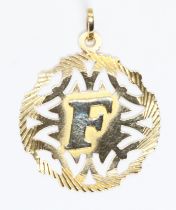 A pendant, initialled 'F', marked '750', gross weight 3.7g.