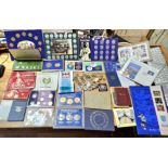 A large collection of assorted world coin sets, covers & coins to include a 50p 1992 coin cover,