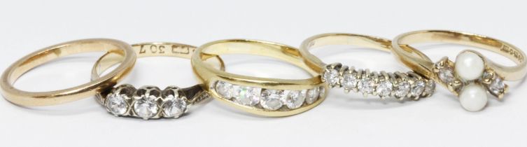 A group of four 9ct gold rings and another unmarked, various settings and marks, gross weight 9.1.g,