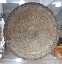 An early 20th century North African/Middle Eastern white metal salver, profusely decorated with