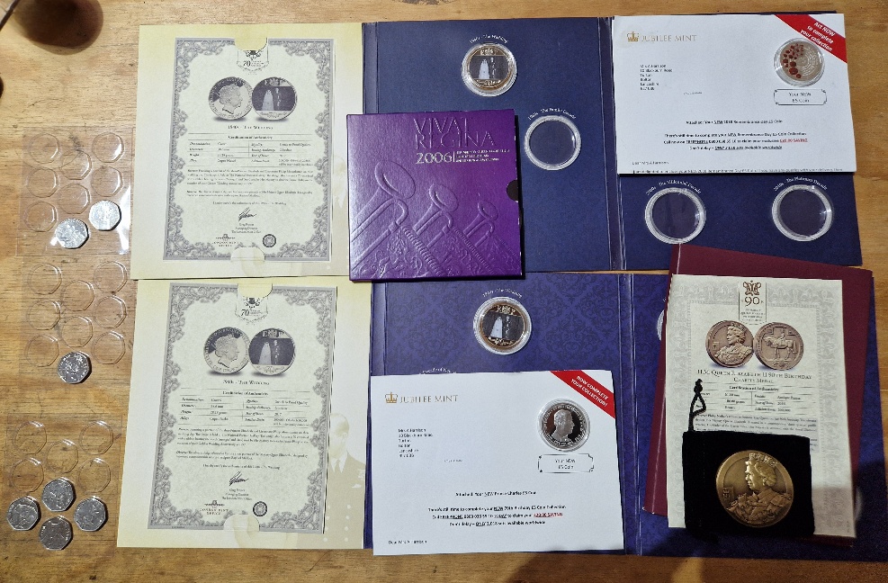 A group of assorted coins to include silver plated commemoratives, Beatrix Potter 50ps & a bronze