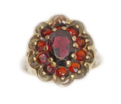 A garnet cluster ring, marked '9ct', gross weight 3.9g, size M. Condition - slight abrasion/