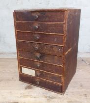 A cabinet of assorted mainly vintage watch spares.