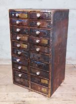 A cabinet of assorted horology spares and tools.