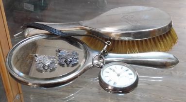 A mixed lot of silver comprising a brush and mirror, two fobs and a pocket watch.