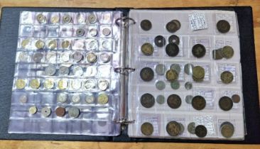 An album of assorted world coins to include some silver etc.