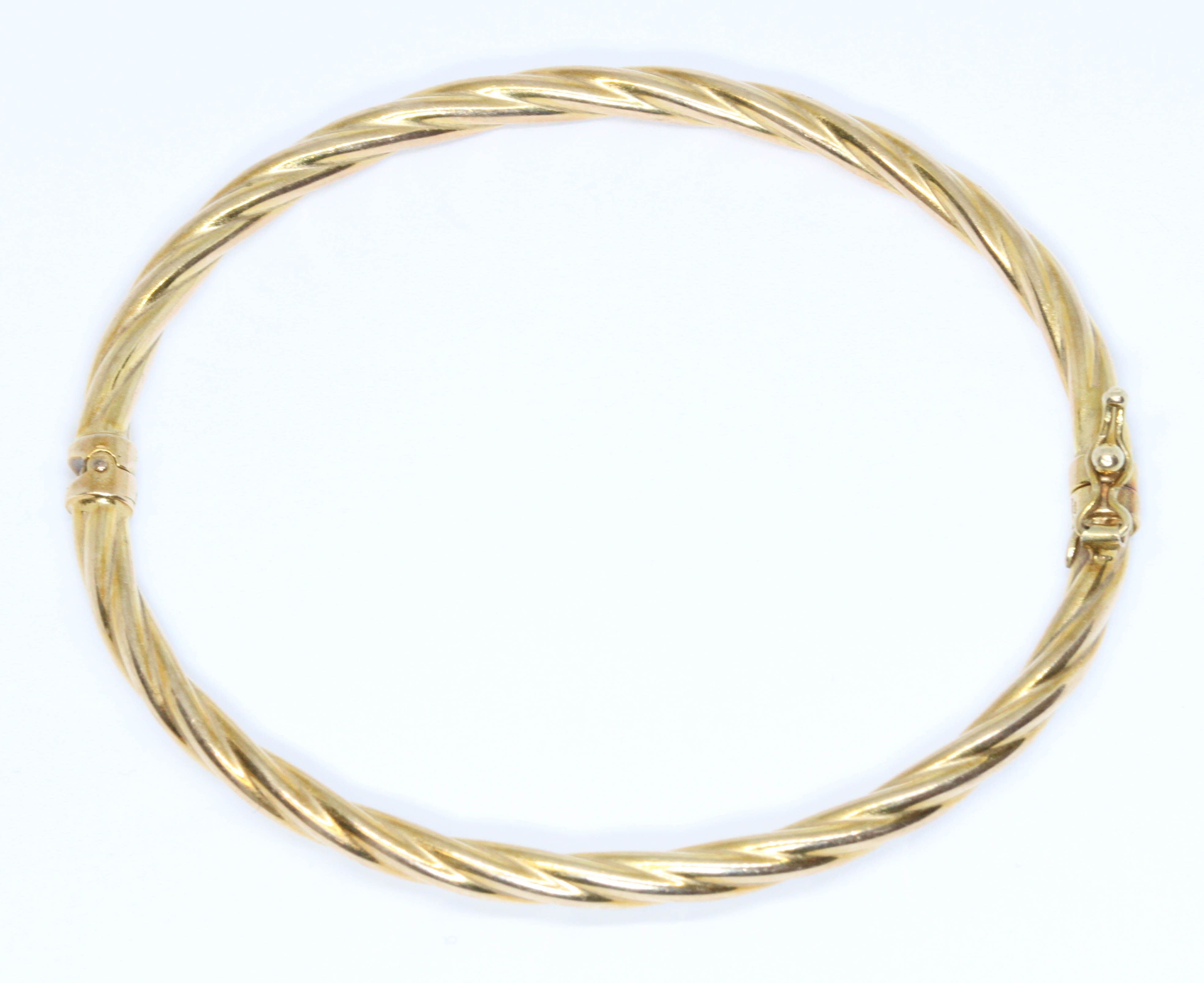 A 9ct twist gold bangle, diameter approximately 58mm, weight 4.3g. Condition - good, general wear.