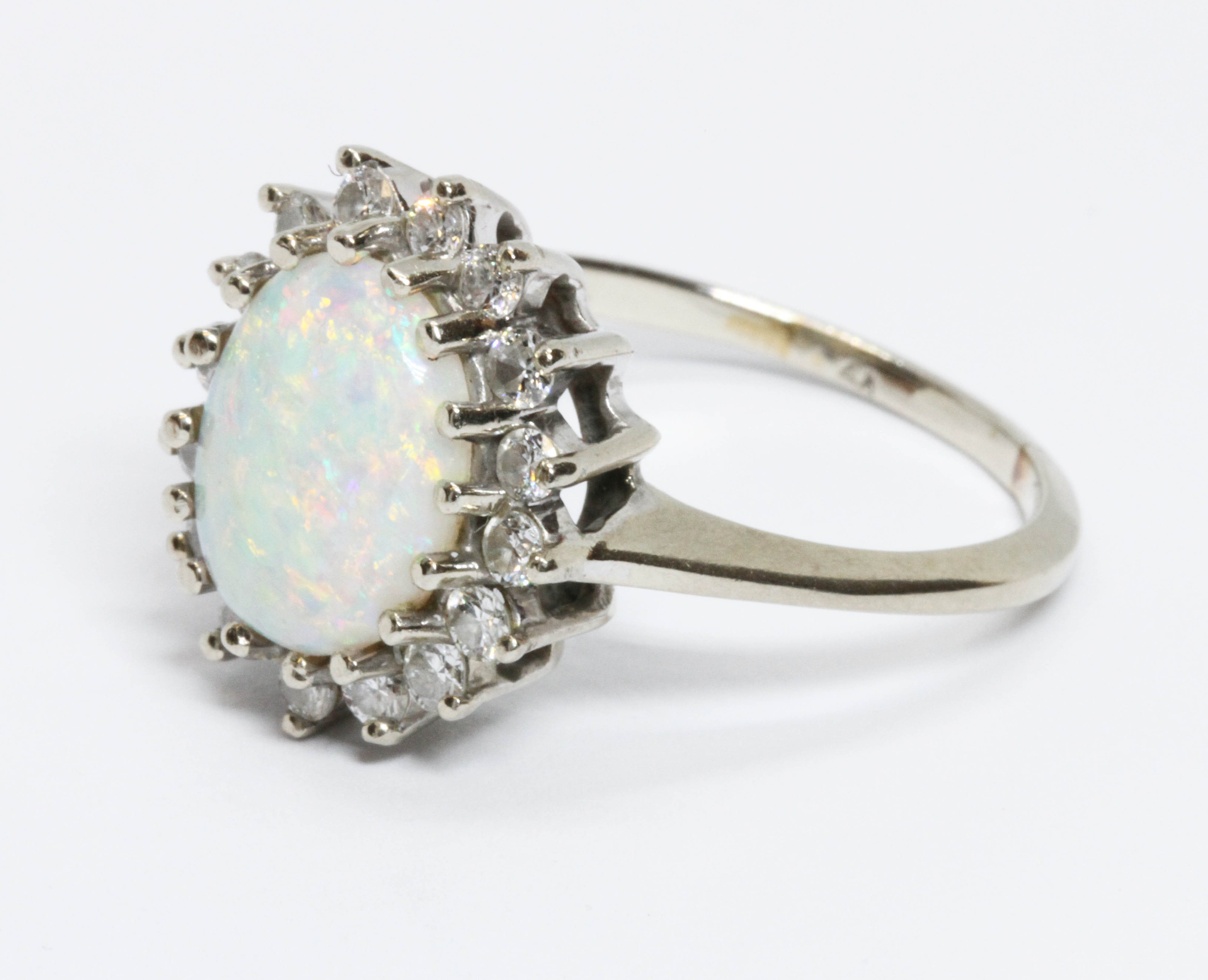 An opal and diamond cluster ring, the oval opal cabochon measuring approximately 12.58mm x 9.93mm, - Image 4 of 4