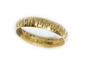 A hallmarked 18ct gold textured wedding band, weight 3g, size Q. Condition - dirt to inside of band,