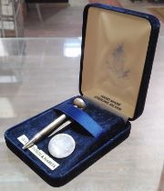 A novelty silver golf tee, pencil and ball marker set.