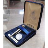 A novelty silver golf tee, pencil and ball marker set.