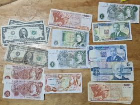 A group of assorted world banknotes to include us 2 dollars etc.