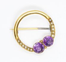 An early 20th century amethyst and split pearl brooch, unmarked, diameter 25mm, gross weight 3.3g.