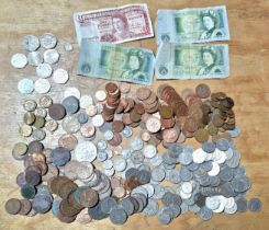 A cash tim of assorted GB coins & banknotes to include modern collectable 50ps etc.