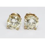 A pair of diamond solitaire ear studs, the round brilliant cut stones weighing approximately 2.99