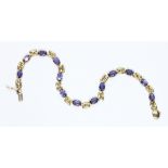 A 9ct gold tanzanite bracelet, international convention marks, length 17.5cm, gross weight 5.3g.