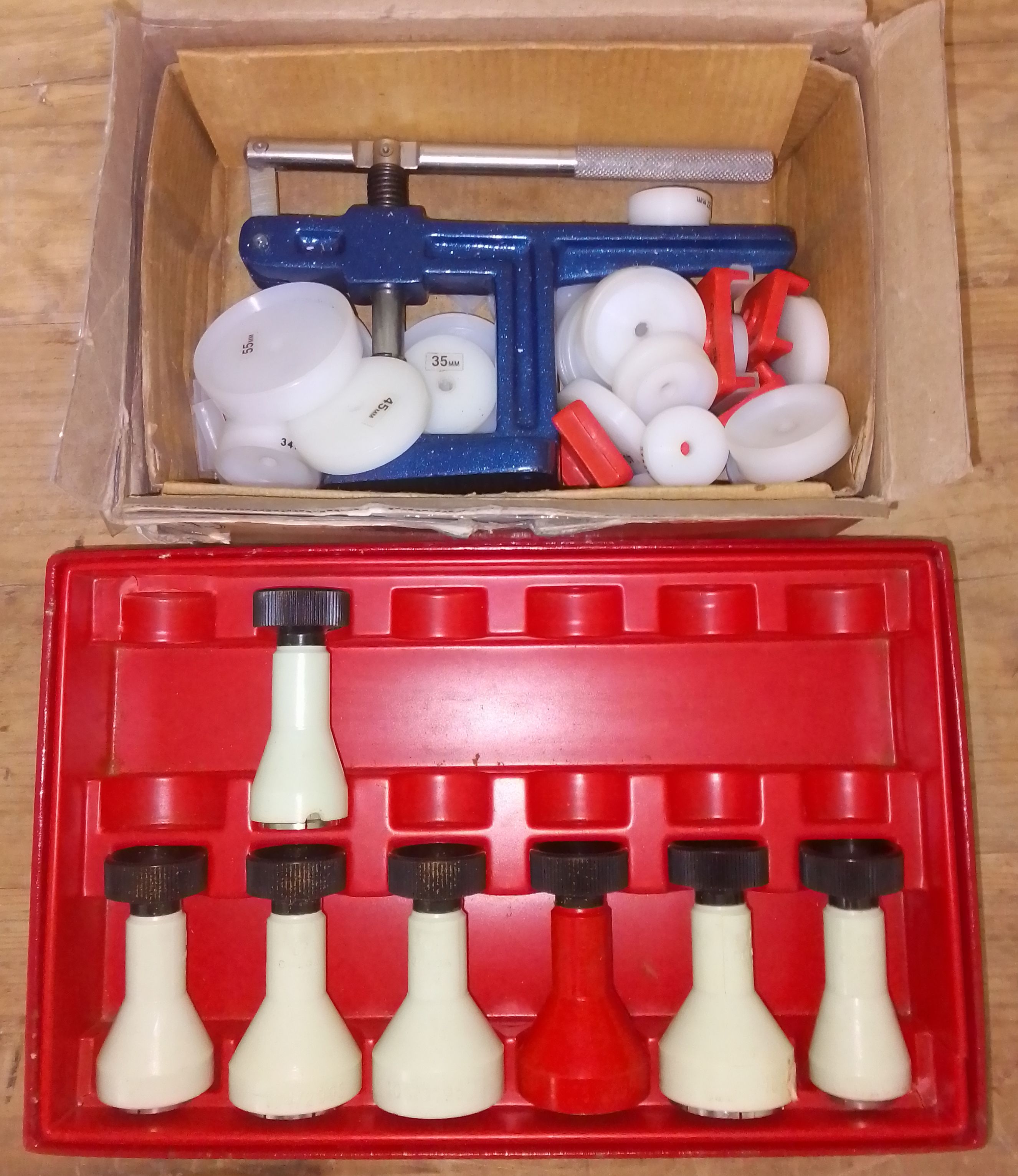 A part set of Omega watch glass fitting tools and an Anchor glass fitting machine.