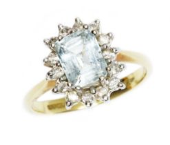 An 18ct gold aquamarine and diamond ring, the emerald cut stone measuring approximately 7.06mm x 5.
