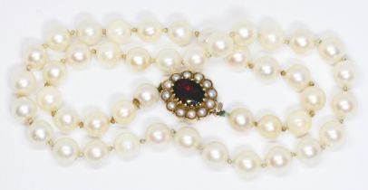 A cultured pear necklace, hallmarked 9ct gold garnet and split pearl clasp, length 36cm, gross