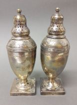 A matched pair of George III silver pepper pots, one hallmarked for Andrew Fogelberg, London 1810,