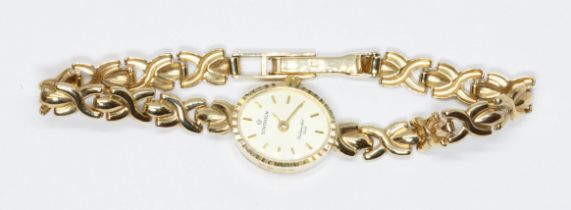 A ladies hallmarked 9ct gold Sovereign wristwatch with integrated strap, gross weight 9.1g.