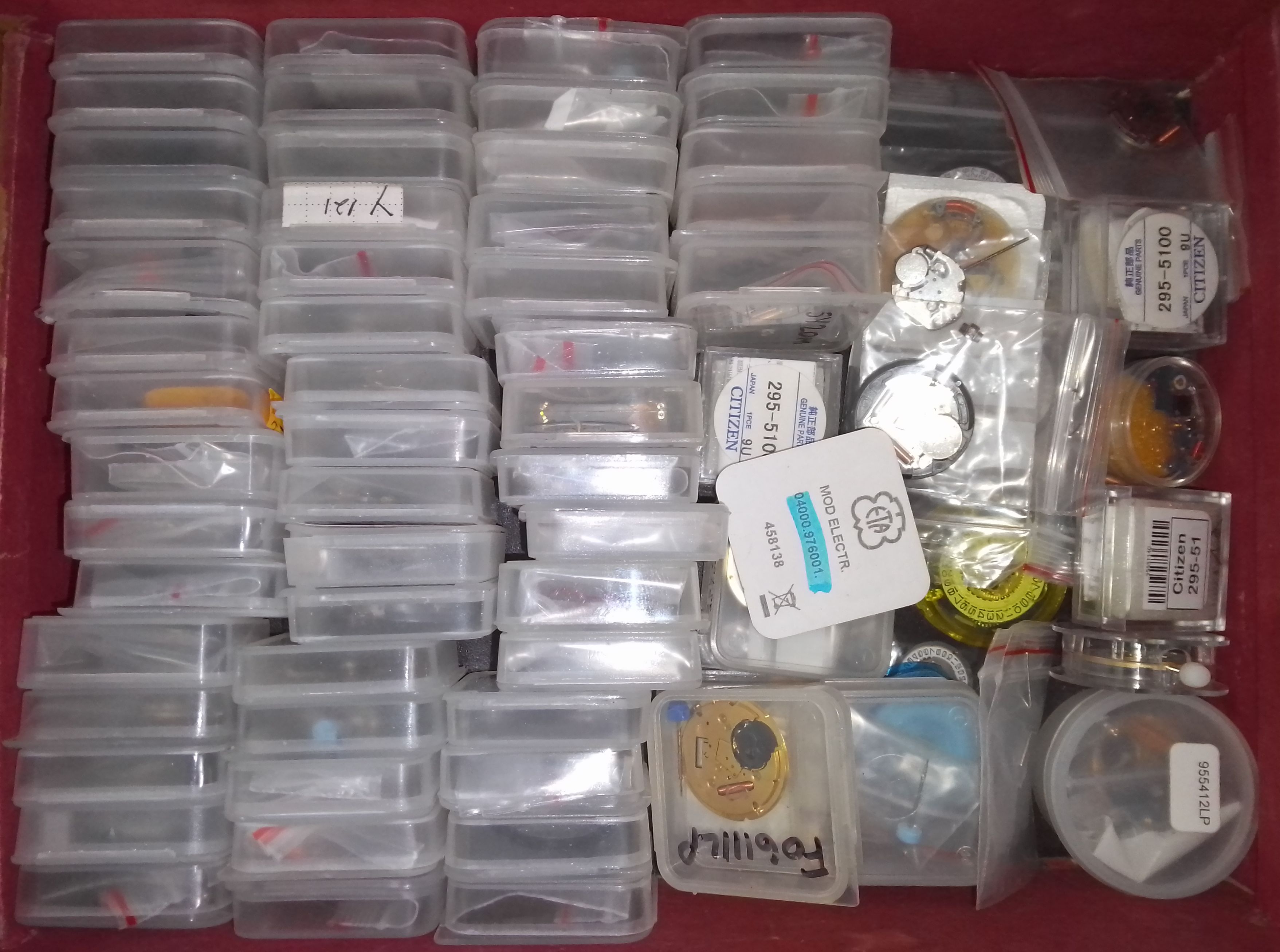 A box of watch movements and parts.