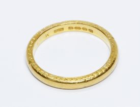 A 22ct gold wedding band, engraved design to sides, sponsor 'H.S', Birmingham 1933, weight 4.8g,