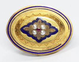 A Victorian yellow metal mourning brooch, set with a central ruby, four split pearls above blue