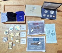 A tub of assorted commemorative copy gold/silver plated coins, silver sixpence, silver