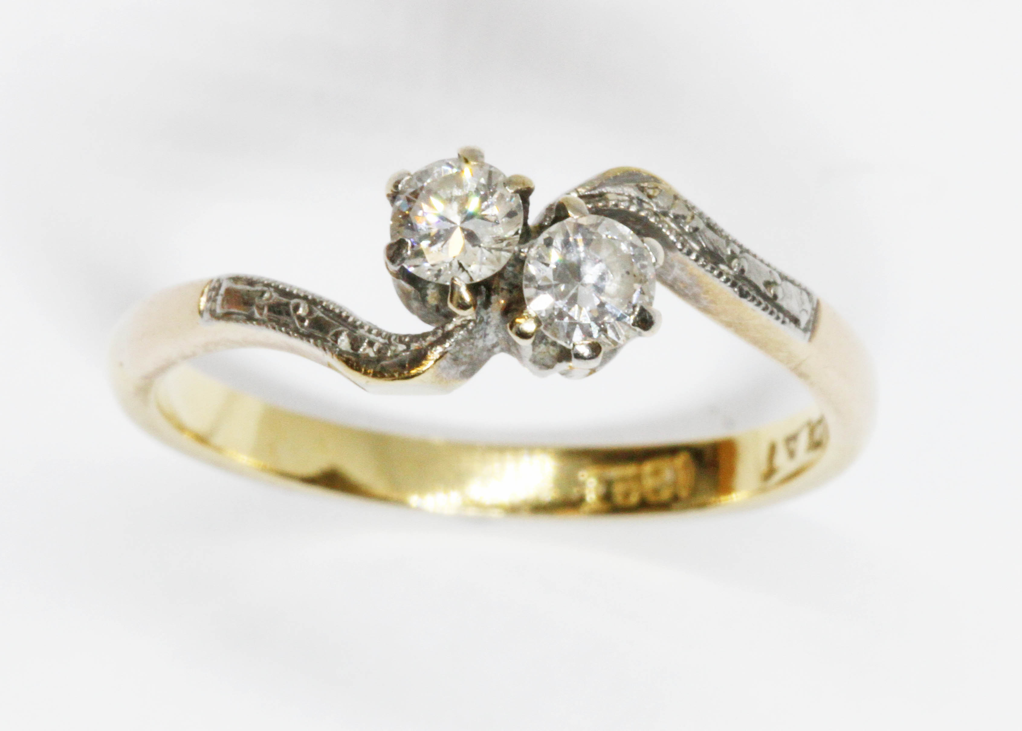 A mid 20th century two stone diamond cross over ring, total diamond weight approximately 0.22