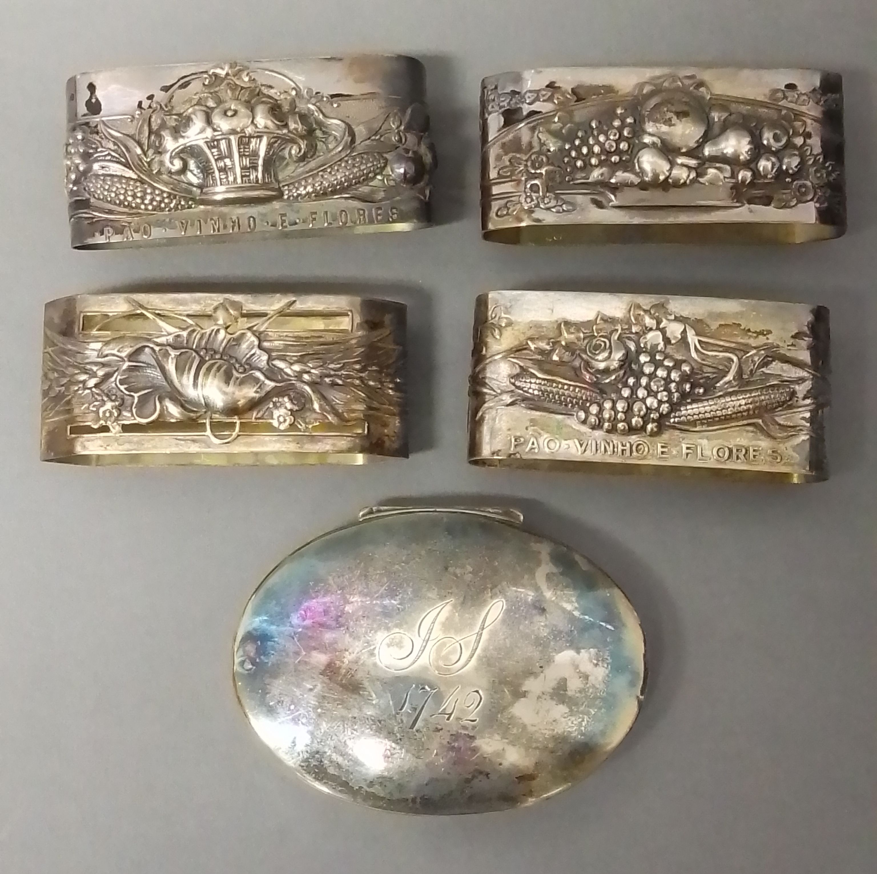 A set of four Portuguese Art Nouveau style silver serviette rings and an 18th century snuff box.
