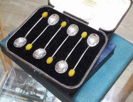 A cased set of hallmarked silver bean spoons with bakelite finials and other boxed cutlery.