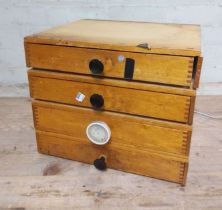 A cabinet of assorted horology spares.