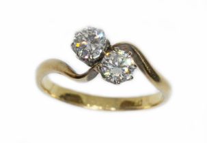 A two stone diamond cross over ring, 0.37 & 0.35 carats, band marked '18ct', gross weight 3.3g, size