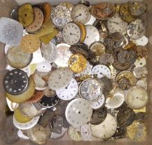 A box of assorted watch movements and dials.
