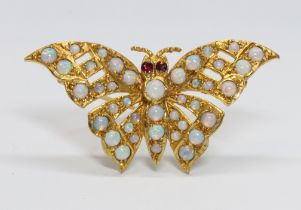 A novelty butterfly brooch, set with opal cabochons all over and rubies for eyes, hallmarked 9ct