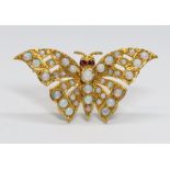 A novelty butterfly brooch, set with opal cabochons all over and rubies for eyes, hallmarked 9ct