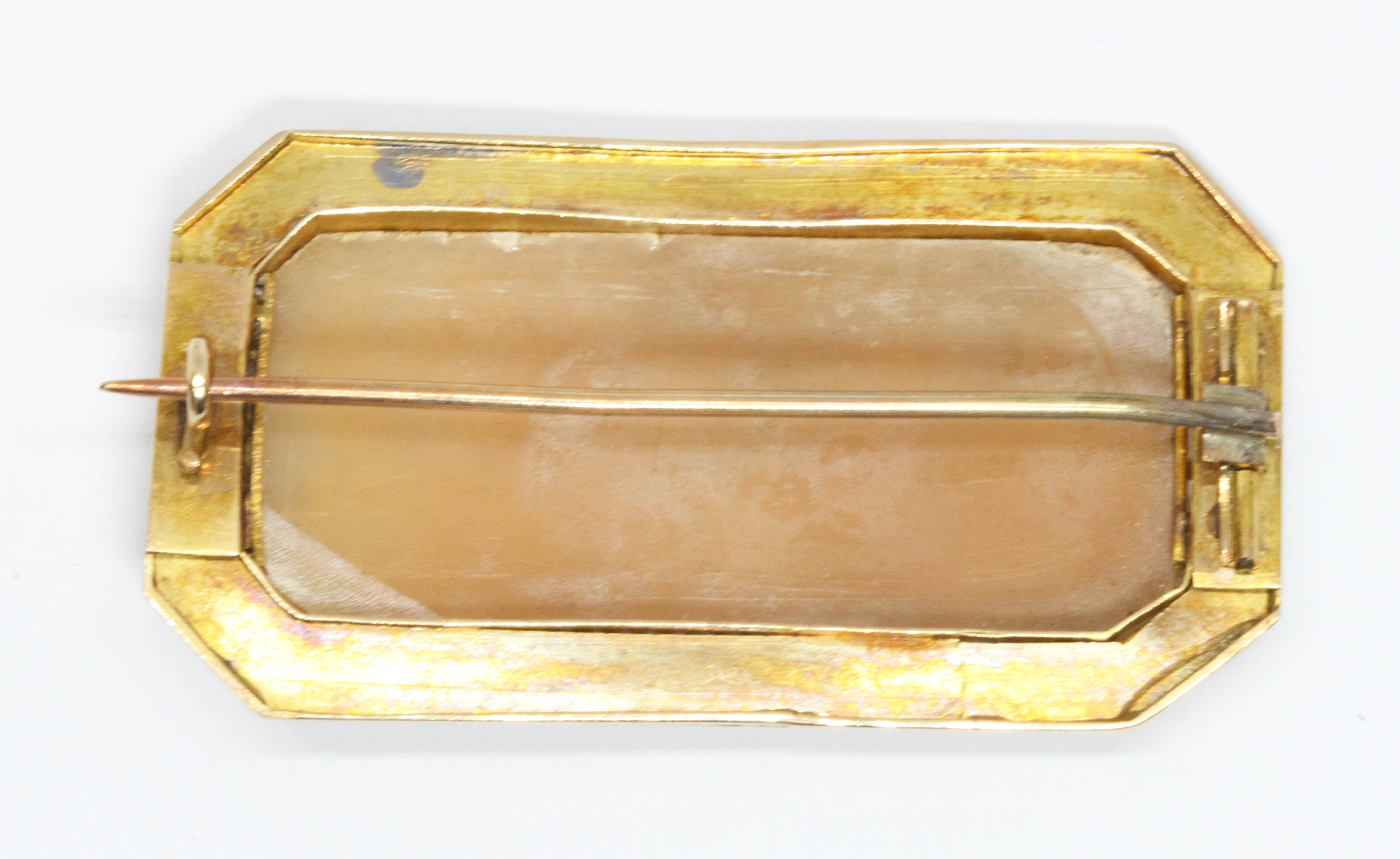 A yellow metal cameo brooch, the rectangular shell cameo depicting figures riding a chariot with - Image 2 of 2