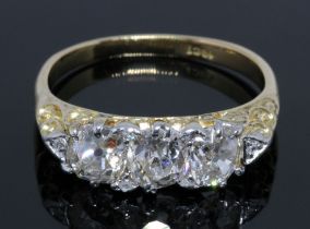 An antique three stone diamond ring, three Old Mine cut diamonds, the principal stone weighing